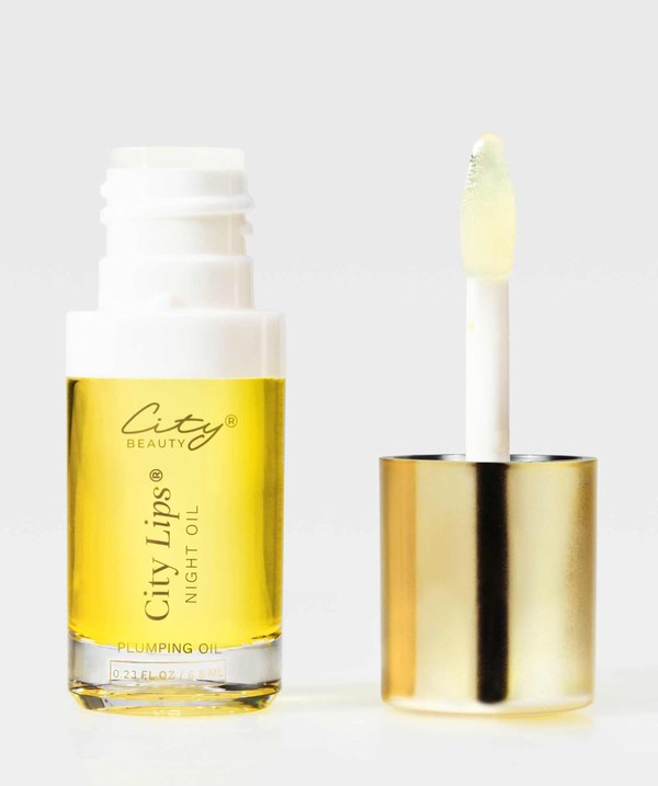 City Beauty City Lips Night Oil bottle next to its wand applicator and gold cap