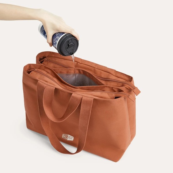 Hand pouring water from a bottle into the waterproof pocket of the Bagsmart Halo work tote
