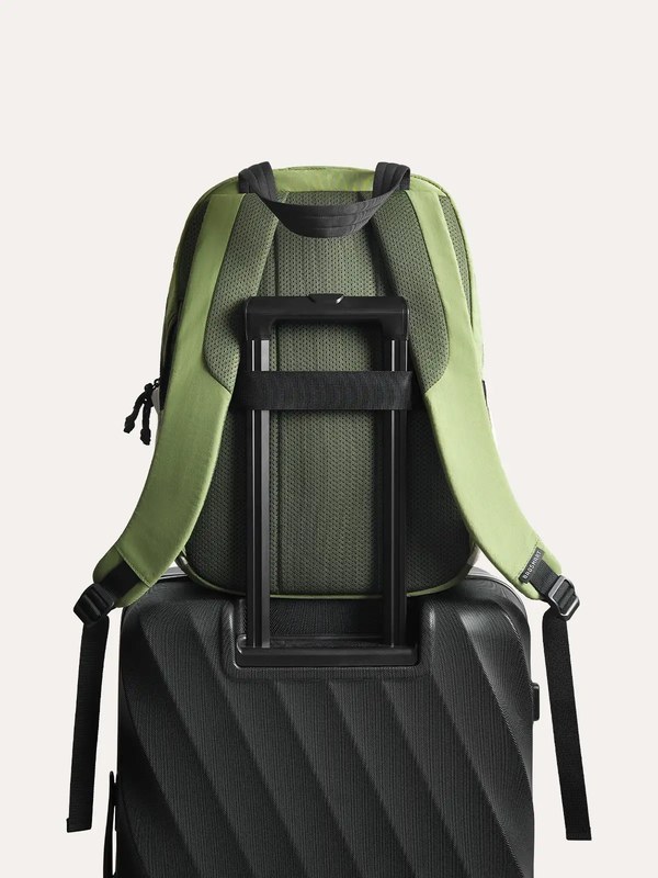 Bagsmart Paz backpack in green attached to a suitcase handle using the luggage pass-through